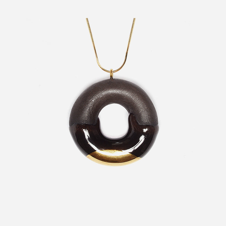 Gold glazed dark chocolate donut