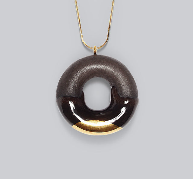 Gold glazed dark chocolate donut
